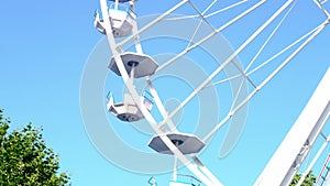 Close-up largest modern carousel ferris wheel fun spinning, an entertaining attraction in the park, the concept of a holiday,