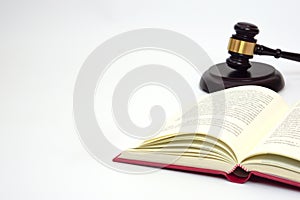 Close up law book and blurred the judge gavel or hammer placed behind.