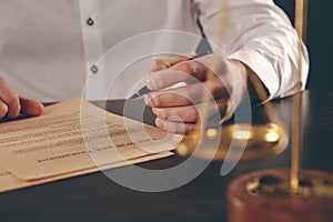 Close up lawyer businessman working or reading lawbook in office workplace.