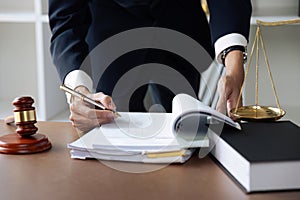 Close up lawyer businessman working or reading lawbook in office workplace for consultant lawyer concept.