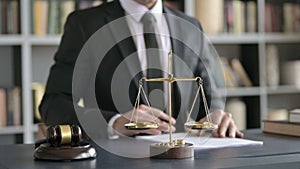 Close up of lawyer hands writing documents in court room