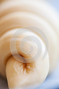 Close up of layers of Semifinished or unbaked croissant on a baking sheet. Puff pastry baking. Selective focus photo