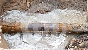 Close-up of leakage in city sewage system ot water pipeline