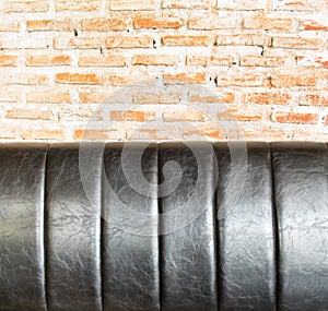 Close up Leather sofa at orange brick wall