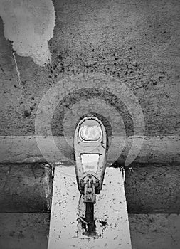 Close up of a LED electric street lamp, black and white moody street photography. Rusty and dirty outdoor urban architecture