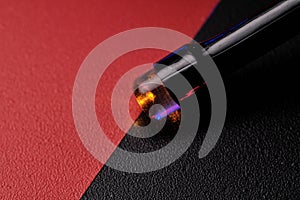 Close-up of an LED light bulb on a red-black background. Selective focus