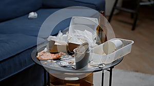 Close up of leftover food on table in empty messy living room