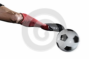 Close up leg and soccer shoe of football player kick ball isolated on white background