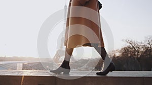 Close-up legs of beautiful happy woman in elegant coat walking near romantic Eiffel tower sky panorama paris slow motion