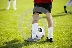 Close up legs and feet of football player in white socks and bl
