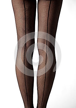 Close-up of legs with fishnet stockings and back line