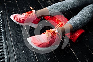 Close-up of the legs of a girl in pink sneakers. The study of fascia of the heel tendons massage sports rollers in the loft