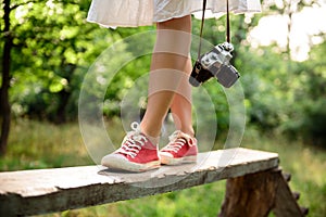 Close up of legs in red keds steping on desk.