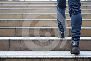Close up legs shoes of young business man One person walking stepping going up the stairs in modern city, go up, success, grow up.