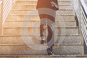 Close up legs shoes of young business man One person walking stepping going up the stairs