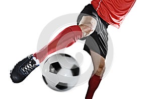 Close up legs and soccer shoe of football player in action kicking ball isolated on white background