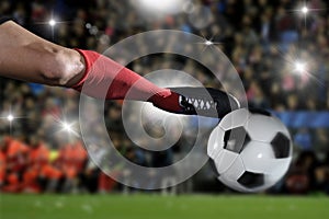 Close up legs and soccer shoe of football player in action kicking ball playing in stadium