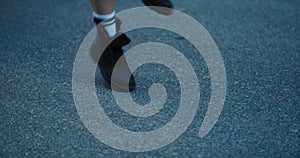 Close-up of the legs of a teenage girl in sneakers dancing a street dance, a young girl is choreographing a workout