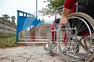 Close-up of legs in a wheelchair. The girl is disabled. The concept of a wheelchair, disabled person, full life, paralyzed,