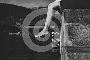 Close up legs woman sitting and feeling depression near river,Mental disorder health care,World suicide prevention day concept,Bla