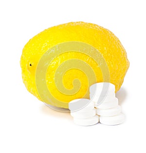 Close up of lemon and pills isolated - vitamin concept