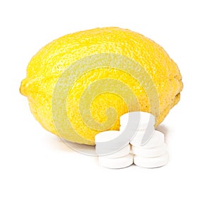 Close up of lemon and pills - vitamin concept