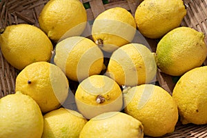 Close up of lemons setting in basket in natural light scene / food material / food background / raw material / food photography