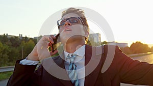 CLOSE UP: Yuppie can't believe what he is hearing during a call with assistant. photo