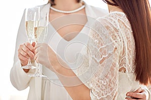 Close up of lesbian couple with champagne glasses
