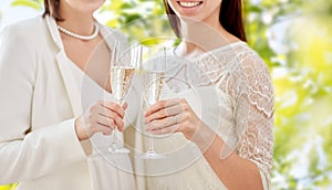 Close up of lesbian couple with champagne glasses