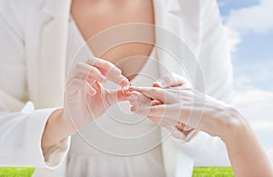 Close up of lesbian couple hands with wedding ring