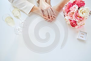 Close up of lesbian couple hands and wedding rings