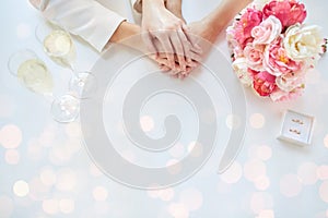 Close up of lesbian couple hands and wedding rings