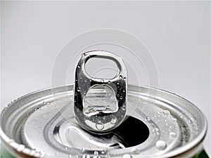 Close up lid opens soft drink can and drops of water grey background