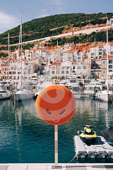 A close-up of a lifebuoy box on a yacht dock at Lustica Bay in Montenegro.