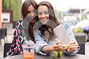 Close up lifestyle selfie portrait of pretty fresh young brunette best friends girls making selfie, having fun