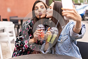 Close up lifestyle selfie portrait of pretty fresh young brunette best friends girls making selfie, having fun