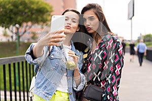 Close up lifestyle selfie portrait of pretty fresh young brunette best friends girls making selfie, having fun