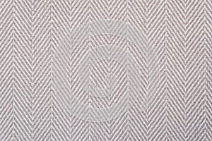 Close-Up of a light beige herringbone fabric pattern for background purposes.
