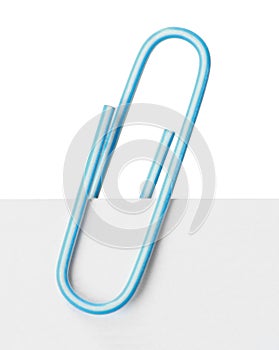 Close up of a light blue paper clip