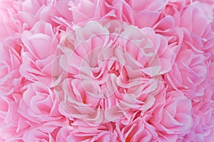 Close up light pink artificial fabric roses group for texture or background