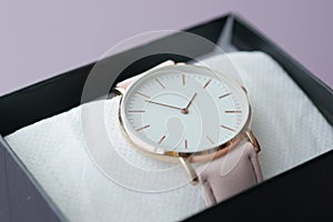 close up of light pink color women watch in a box