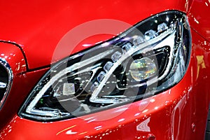 Close up light on red sport car.