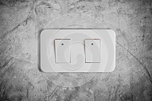 Close-up light switch on concrete wall