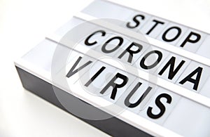 Close up of lightbox with stop corona virus words