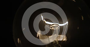 Close-up of a lightbulb on a black background.