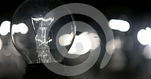 Close-up of a lightbulb on a black background.