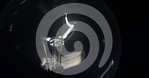 Close-up of a lightbulb on a black background.