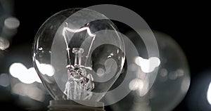 Close-up of a lightbulb on a black background.