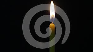 Close-up lighting candle. burning candle flame on black background